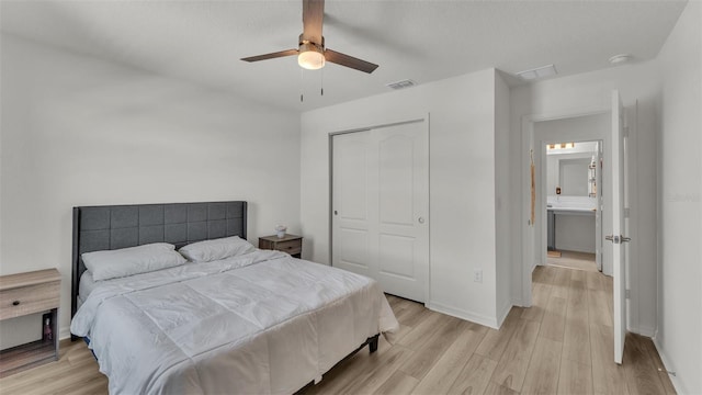 bedroom featuring visible vents, light wood-style floors, a closet, baseboards, and ceiling fan