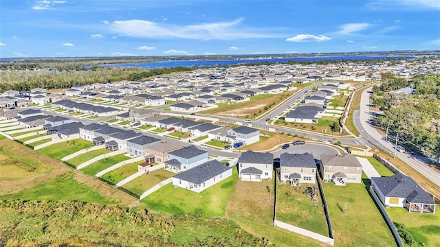 birds eye view of property with a residential view and a water view