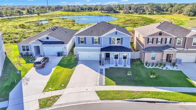 birds eye view of property featuring a water view