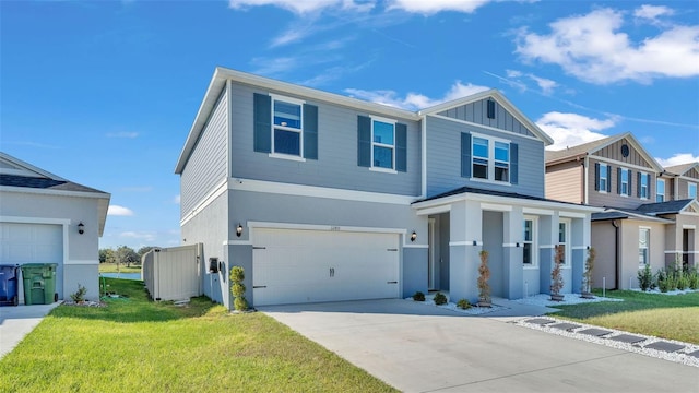 traditional-style home featuring driveway, a garage, board and batten siding, and a front yard