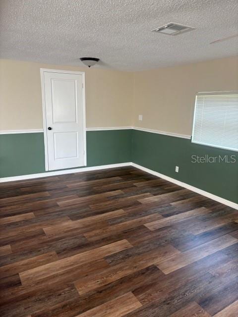 4830 Melody Ln, Lakeland, FL 33805 - spare room with visible vents, wood finished floors, and a textured ceiling