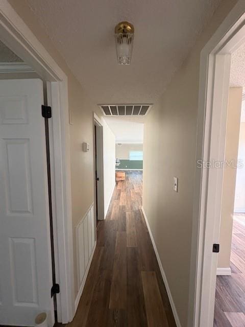 4830 Melody Ln, Lakeland, FL 33805 - hallway featuring visible vents, dark wood-style flooring, and baseboards