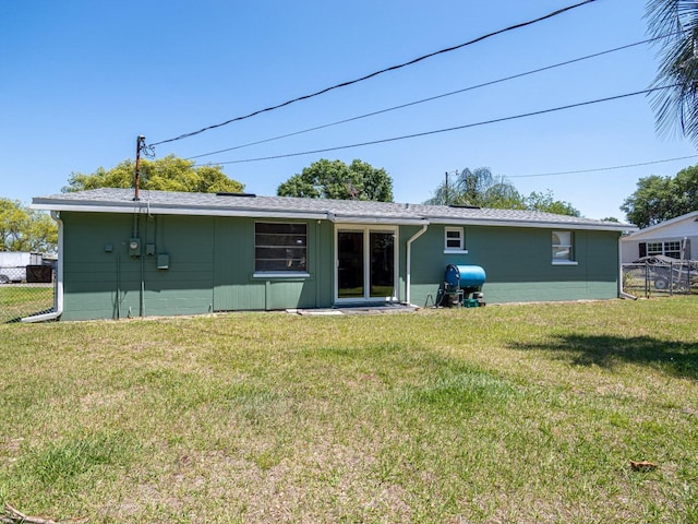 4830 Melody Ln, Lakeland, FL 33805 - rear view of house with fence and a yard