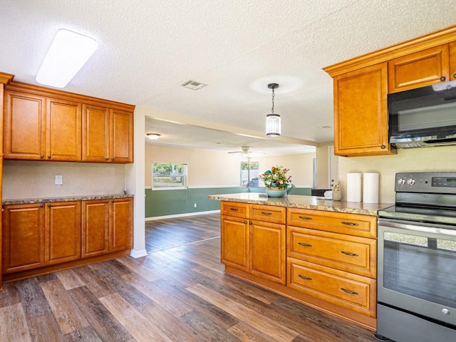 4830 Melody Ln, Lakeland, FL 33805 - kitchen with baseboards, visible vents, brown cabinetry, black microwave, and electric stove