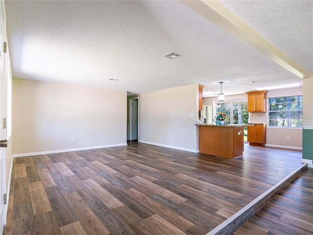 4830 Melody Ln, Lakeland, FL 33805 - unfurnished living room with dark wood finished floors, baseboards, a textured ceiling, and visible vents