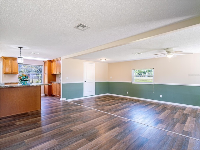 4830 Melody Ln, Lakeland, FL 33805 - interior space with a textured ceiling, visible vents, dark wood-style flooring, and a healthy amount of sunlight