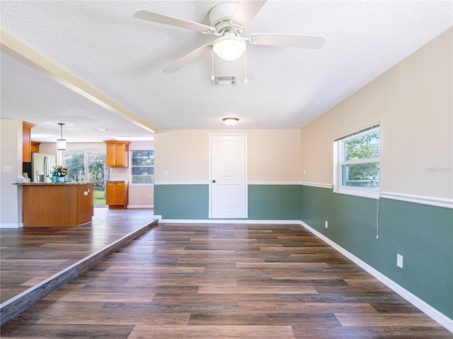 4830 Melody Ln, Lakeland, FL 33805 - spare room with dark wood finished floors, ceiling fan, a textured ceiling, and plenty of natural light