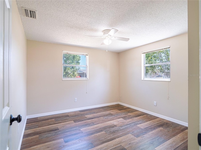 4830 Melody Ln, Lakeland, FL 33805 - spare room with a ceiling fan, wood finished floors, a textured ceiling, baseboards, and visible vents