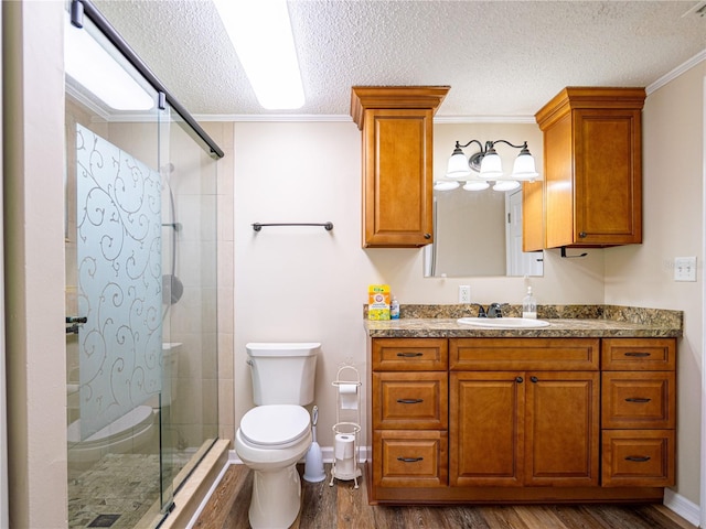 4830 Melody Ln, Lakeland, FL 33805 - full bathroom featuring wood finished floors, toilet, crown molding, a textured ceiling, and a stall shower