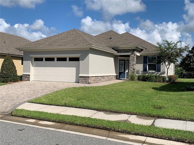 7779 Lake James Blvd, Lakeland, FL 33810 - view of front of property featuring stone siding, an attached garage, and stucco siding