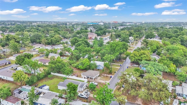 aerial overview of property's location featuring nearby suburban area and a tree filled landscape