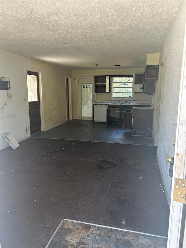 unfurnished living room featuring a textured ceiling and unfinished concrete flooring