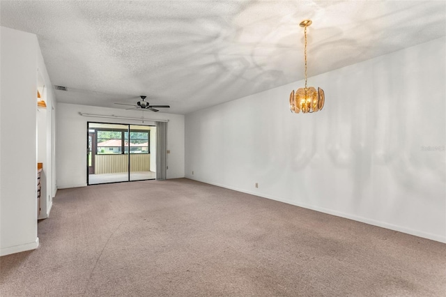 carpeted spare room with a textured ceiling, visible vents, and ceiling fan with notable chandelier