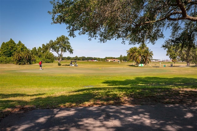 view of home's community with a yard and golf course view