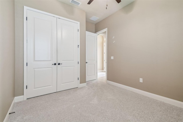 unfurnished bedroom with carpet flooring, baseboards, visible vents, a ceiling fan, and a closet