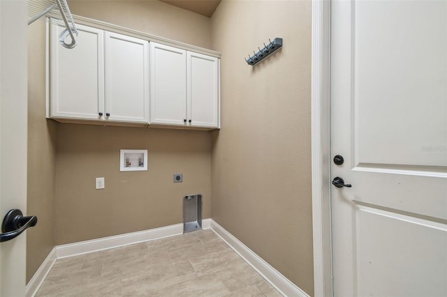 washroom featuring hookup for an electric dryer, cabinet space, hookup for a washing machine, and baseboards