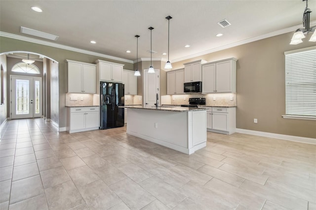kitchen featuring arched walkways, ornamental molding, decorative backsplash, and black appliances