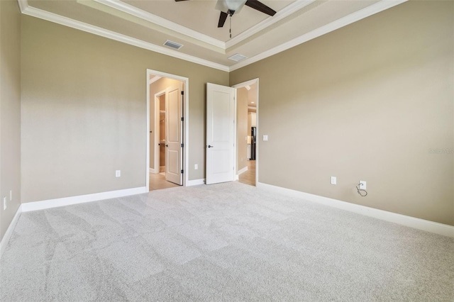 spare room featuring visible vents, a ceiling fan, light colored carpet, and ornamental molding