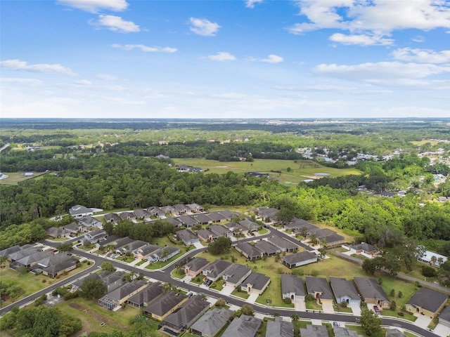 bird's eye view featuring a forest view and a residential view