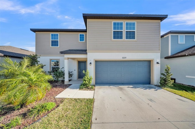 traditional-style home with stucco siding, driveway, and a garage