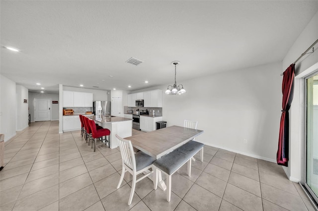 dining area featuring an inviting chandelier, baseboards, recessed lighting, and light tile patterned floors