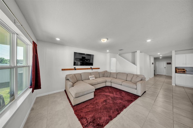 living room with recessed lighting, a healthy amount of sunlight, and light tile patterned floors