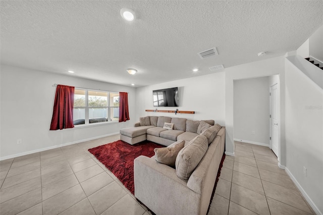 living area featuring visible vents, a textured ceiling, recessed lighting, and light tile patterned flooring