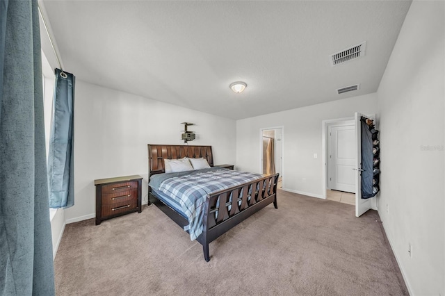 bedroom with light colored carpet, baseboards, and visible vents