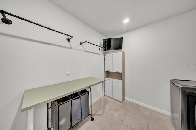 laundry room featuring recessed lighting, light tile patterned floors, washer / dryer, and baseboards