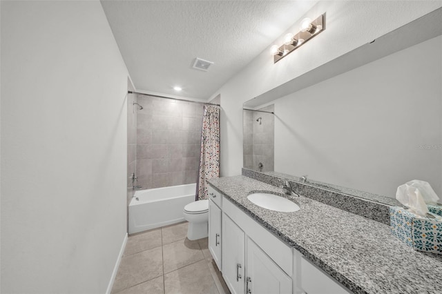 full bathroom featuring tile patterned flooring, visible vents, toilet, vanity, and a textured ceiling