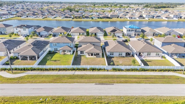 drone / aerial view featuring a water view and a residential view