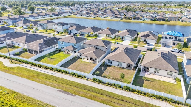 drone / aerial view with a water view and a residential view