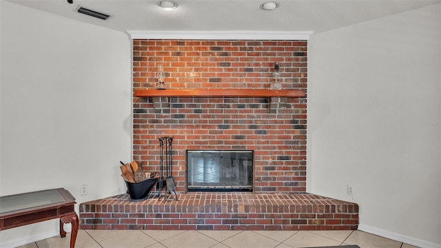 room details with visible vents, baseboards, and a brick fireplace