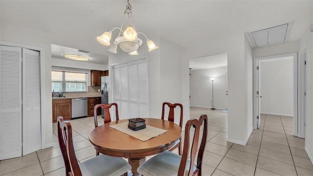 dining area featuring attic access, baseboards, and light tile patterned floors