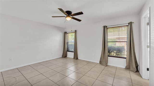 unfurnished room featuring light tile patterned floors, baseboards, and ceiling fan