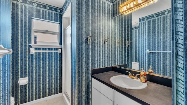 bathroom featuring tile patterned flooring, wallpapered walls, and a stall shower