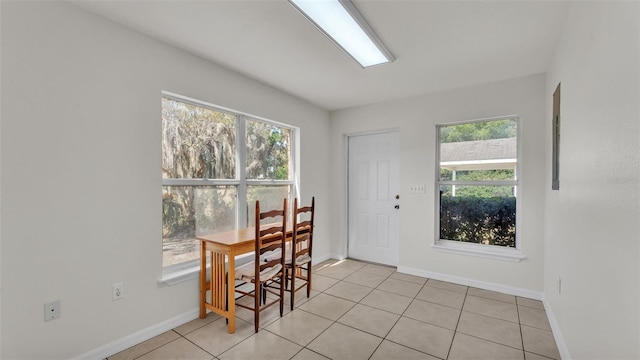 dining area featuring plenty of natural light, baseboards, and light tile patterned flooring