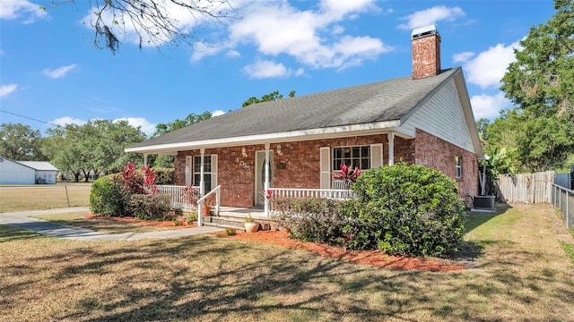 view of front of home featuring brick siding, a front yard, and covered porch