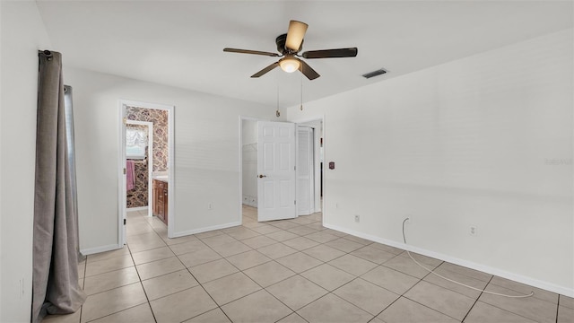 spare room with visible vents, baseboards, ceiling fan, and light tile patterned floors