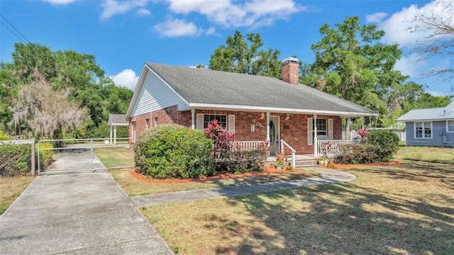 bungalow featuring a chimney, fence, concrete driveway, covered porch, and brick siding