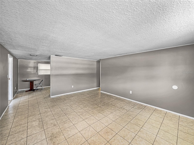 1720 Kendrick Ln, Lakeland, FL 33805 - empty room featuring light tile patterned floors, a textured ceiling, and baseboards