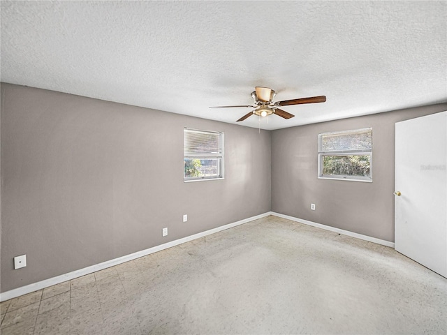1720 Kendrick Ln, Lakeland, FL 33805 - spare room with a textured ceiling, plenty of natural light, a ceiling fan, and baseboards