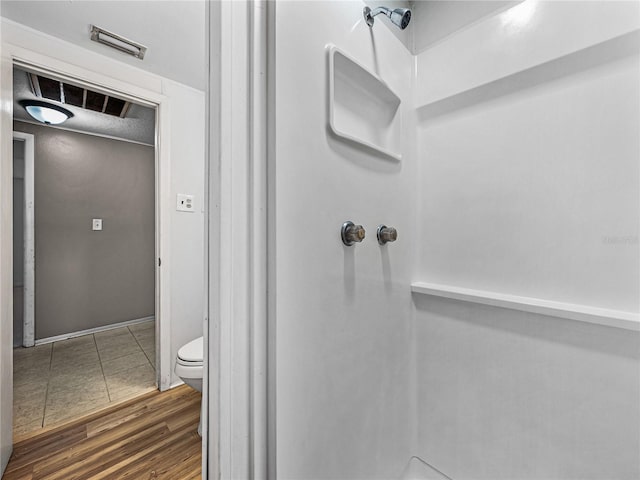 1720 Kendrick Ln, Lakeland, FL 33805 - bathroom featuring toilet, a shower, and wood finished floors