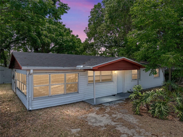 1720 Kendrick Ln, Lakeland, FL 33805 - back of property at dusk featuring a shingled roof