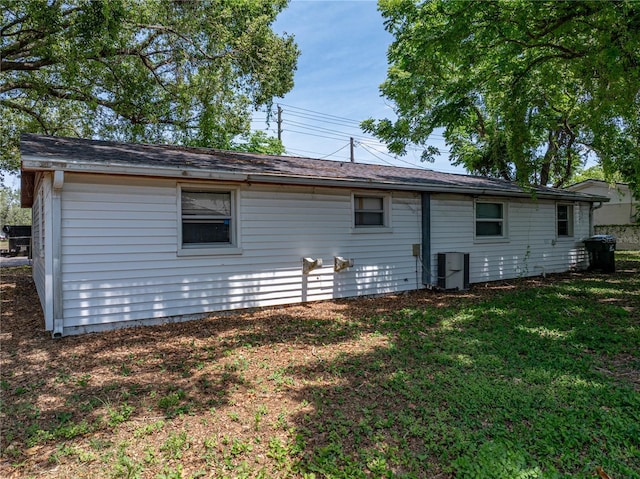 1720 Kendrick Ln, Lakeland, FL 33805 - back of house with a lawn and central AC
