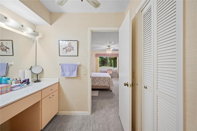 bathroom with a ceiling fan, ensuite bathroom, a closet, vanity, and baseboards