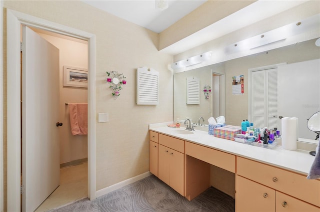 bathroom with baseboards and vanity