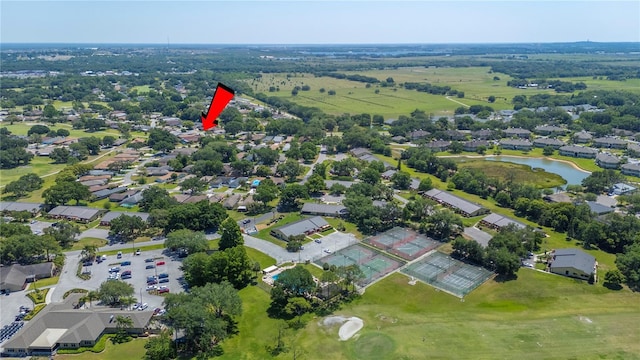 aerial view with a residential view, golf course view, and a water view