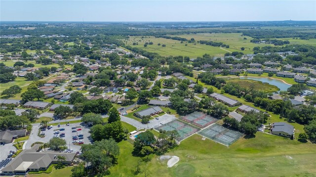 aerial view with a residential view, golf course view, and a water view