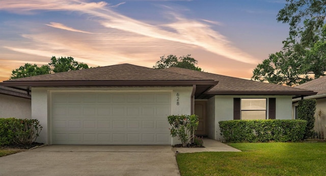 view of front of home with concrete driveway, an attached garage, and stucco siding